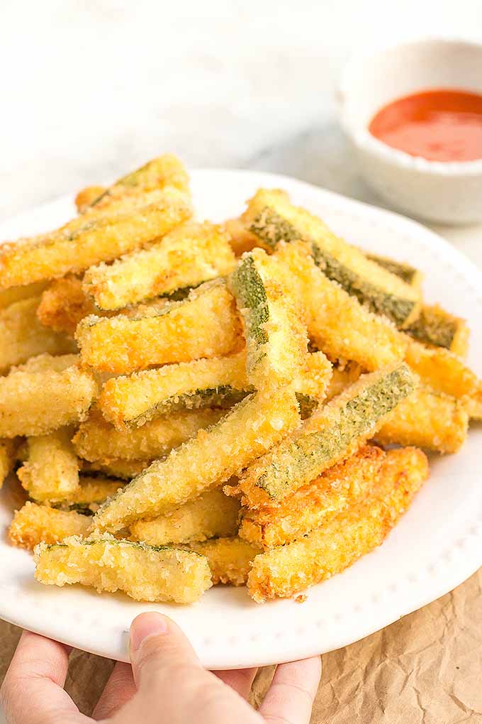 These deep-fried zucchini fries have a crispy, golden exterior, and a tender, melt-in-your-mouth bite on the inside. We share the recipe: https://foodal.com/recipes/appetizers/deep-fried-zucchini-fries/