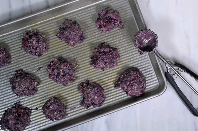 Raw dough balls on a baking tray.