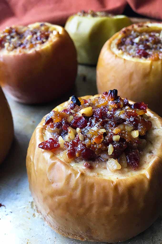 Close up of baked granny smith apple stuffed with dried cranberries and nuts.