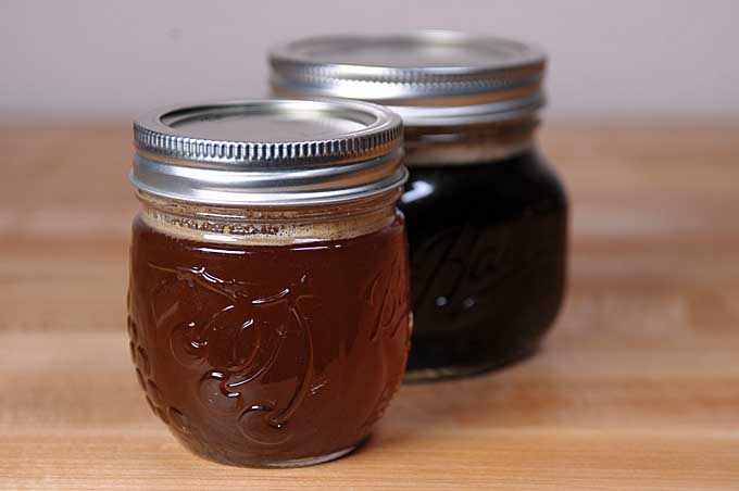 Two jars of brown butter sitting on wooden table | Foodal