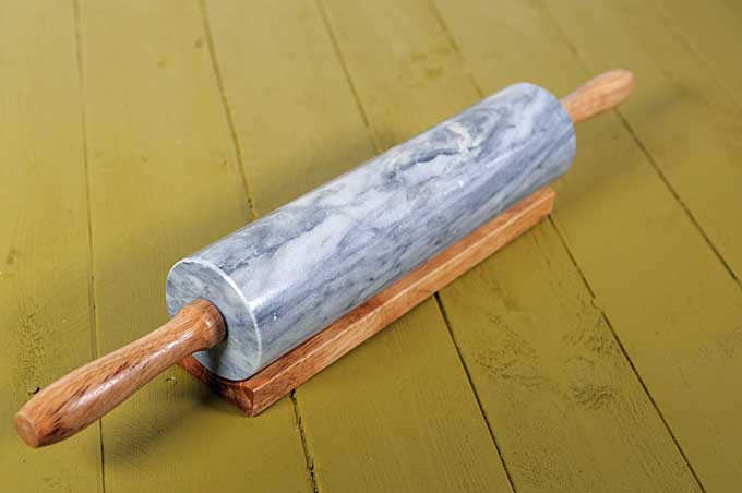 The Fox Run Marble Rolling Pin on a green wooden background | Foodal