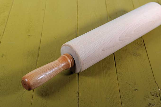 Close up of the J.K. Adams traditional rolling pin on a green wooden table top | Foodal