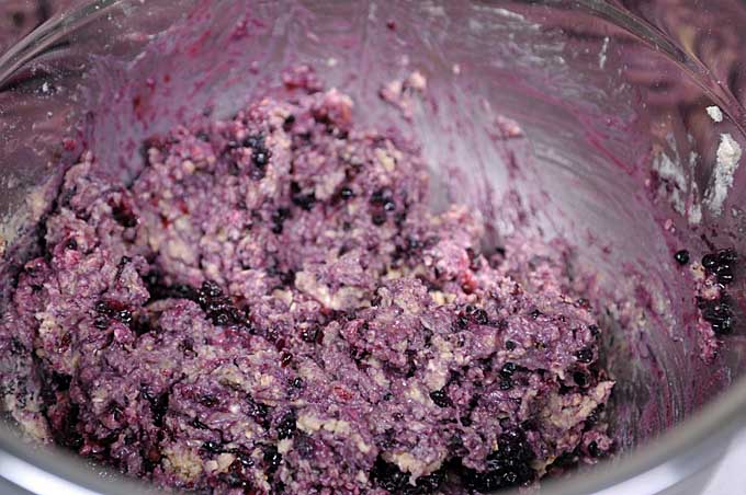 Blackberries being added to the dough in the bowl | Foodal
