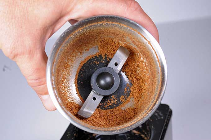 Nutmeg ground in a blade style coffee grinder | Foodal