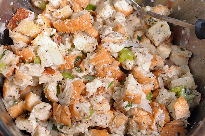 Top down view of bread stuffing in a mixing bowl ready to be served or placed inside of a Turkey | Foodal