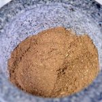 A mortar full of fully ground homemade poultry seasoning | Foodal