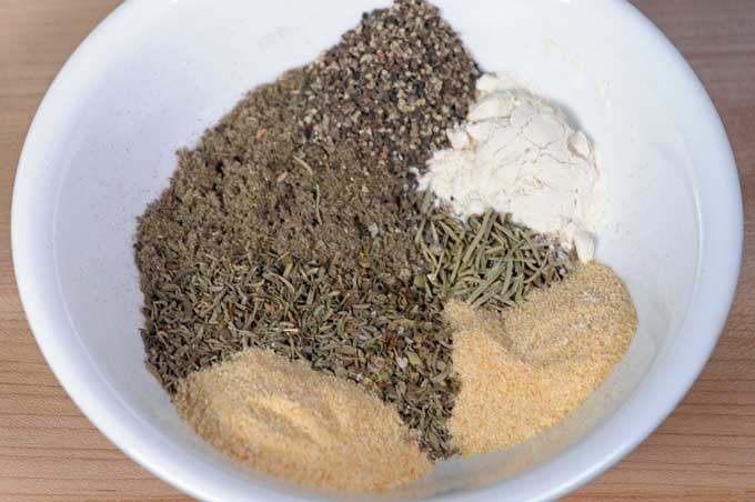 Sage and other spices in white, ceramic bowl for ingredients for a dry rub | Foodal