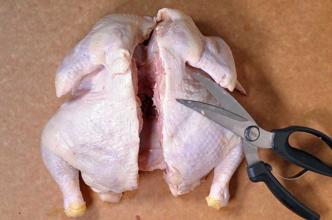 The bird is shown breast down and back up with its spinal column and backbone completely cut out | Foodal