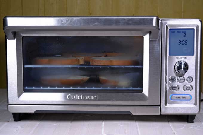 Front view of a Cuisinart toaster oven toasting bread slices | Foodal