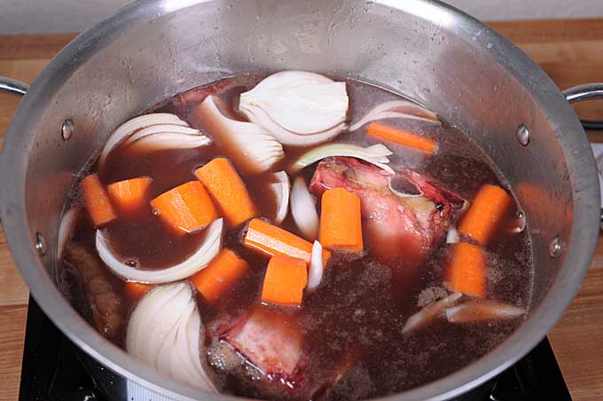 All of the raw ingredients required to make Au Jus added to a stock pot | Foodal