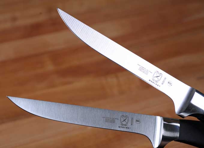 A pair of Mercer Genesis Boning Knives: one with a stiff blade and one with a flexible blade | Foodal
