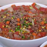 A large white ceramic bowl containing most of the hamburger soup | Foodal