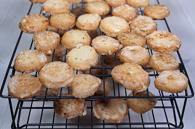 Bake rosemary butter cookies resting on a double stacked cooking rack | Foodal