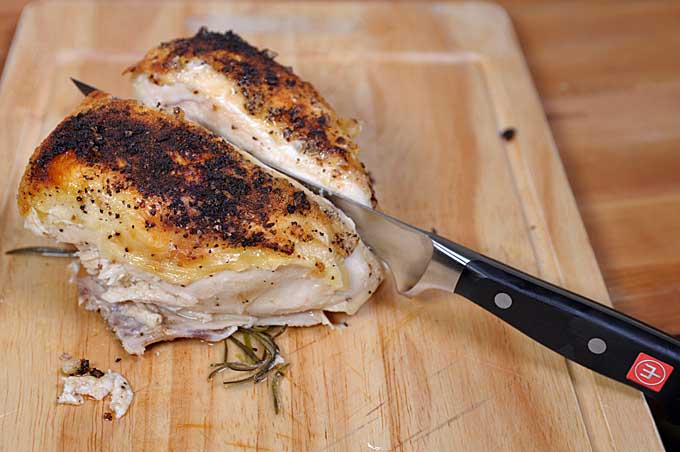 A Wusthof Classic Flexible Boning Knife use to carve up a roasted chicken breast | Foodal
