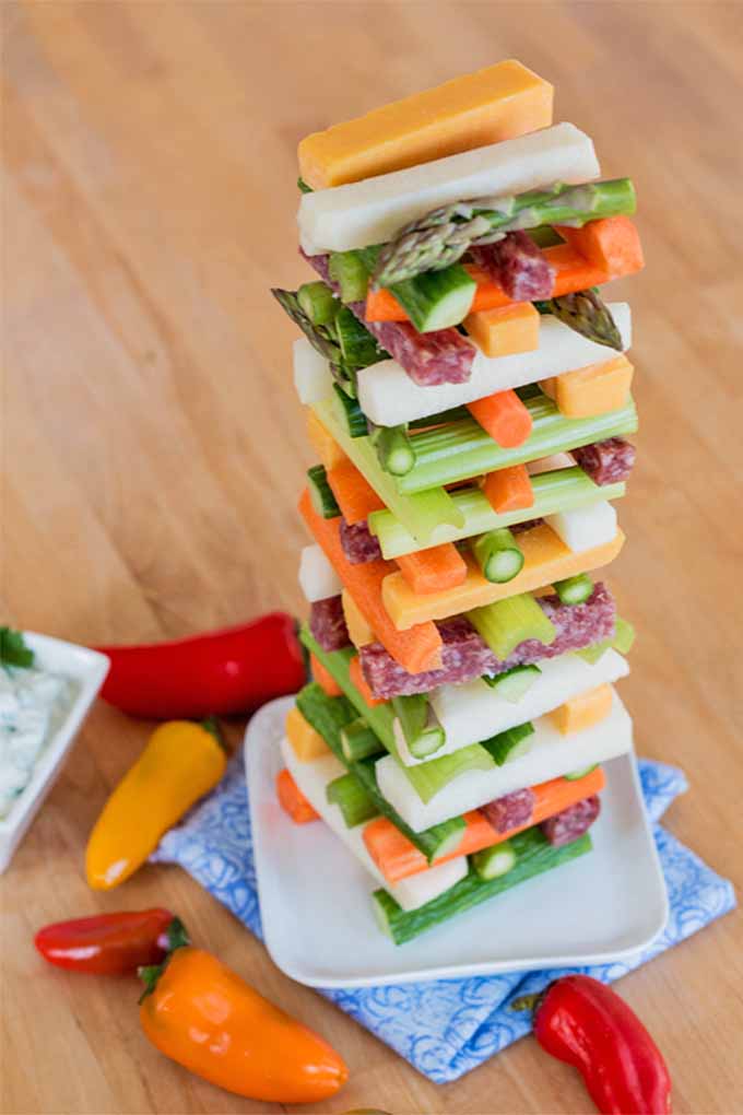 A Jenga-style stack of vegetable sticks, cheese, and pepperoni.