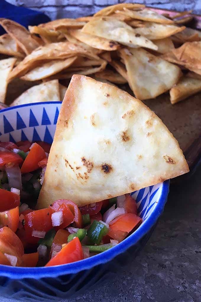 Tired of store-bought bags of nachos? Put down the bag, and get in your kitchen! Make your own fried tortilla chips, using our easy recipe now: https://foodal.com/recipes/snacks/homemade-tortilla-chips/