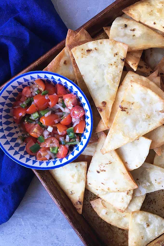 Homemade fried tortilla chips are crispy triangles perfect for dipping in your favorite salsa, guacamole, or hummus. We share the recipe: https://foodal.com/recipes/snacks/homemade-tortilla-chips/