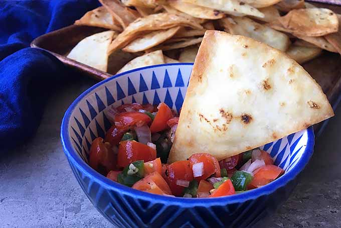 Dipping a Freshly Fried Tortilla Chip in Salsa | Foodal.com