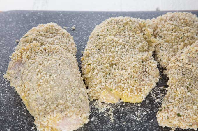 Chicken breasts covered in bread crumbs | Foodal