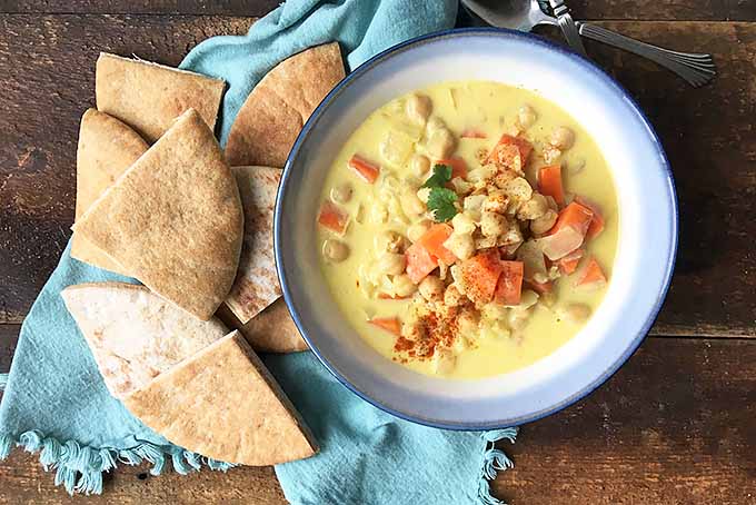 Vegetable stew with beans and rice with pita chips | Foodal.com