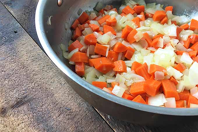 Cooking onions and carrots for a soup | Foodal.com