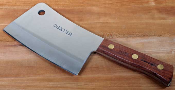Dexter Heavy-Weight Meat Cleaver on a maple wooden cutting board.
