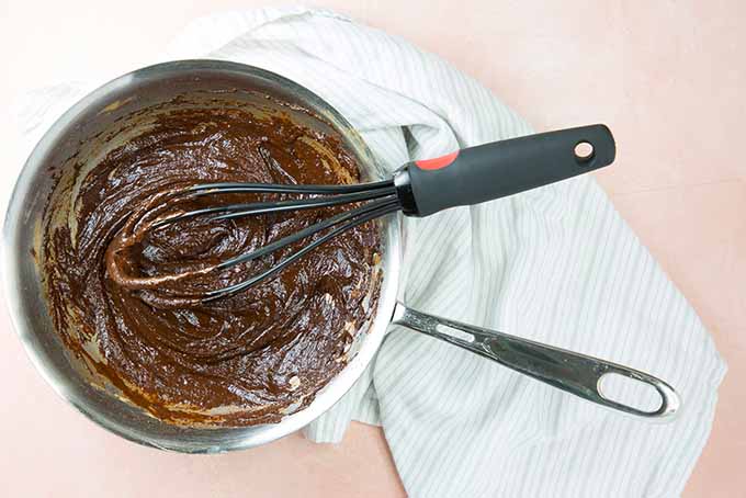 Whisking a chocolate mixture in a pot.