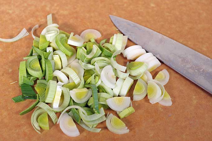 Leeks being sliced up on a Epicurean cutting board with a Japanese Gyuto knife