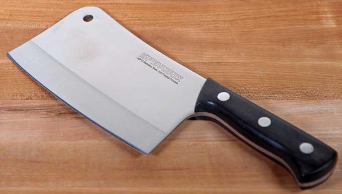 Spevorix Medium-Weight Meat Cleaver on a maple wood cutting block.