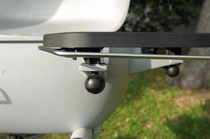 A close up of the release knobs on the side shelves of a PK360 grill.