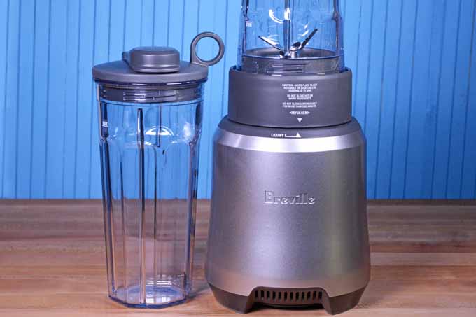 A silver Breville Boss to Go Personal Blender on a blue background.
