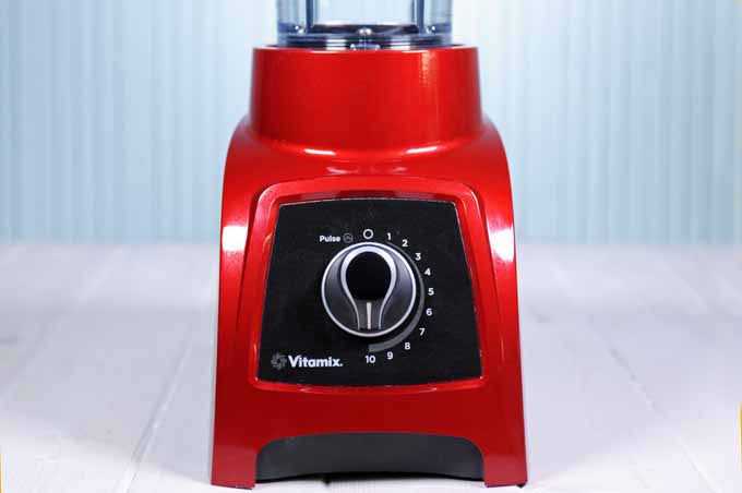 A closeup of a red Vitamix S30 Personal Blender lower base.