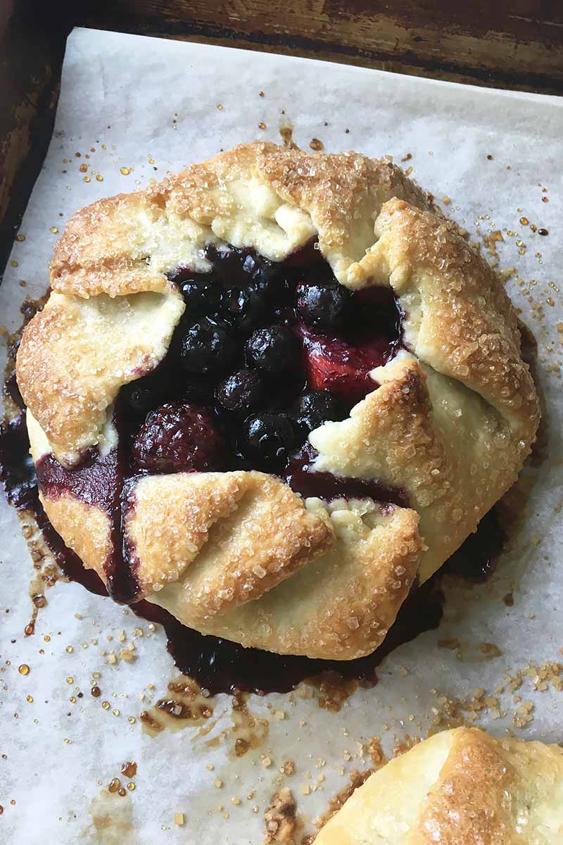 Vertical image of a summer berry galette.