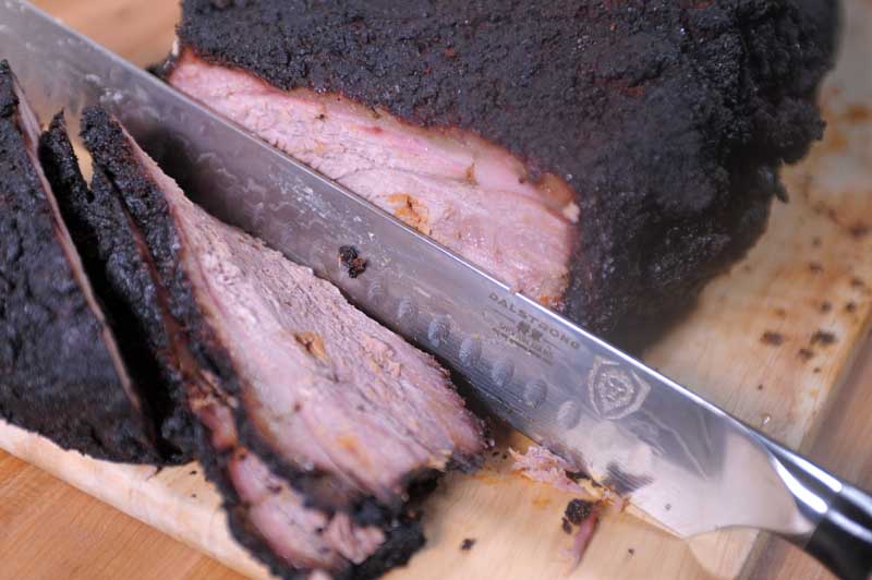 Slicing a smoked brisket with a Dalstrong Shogun Slicer.