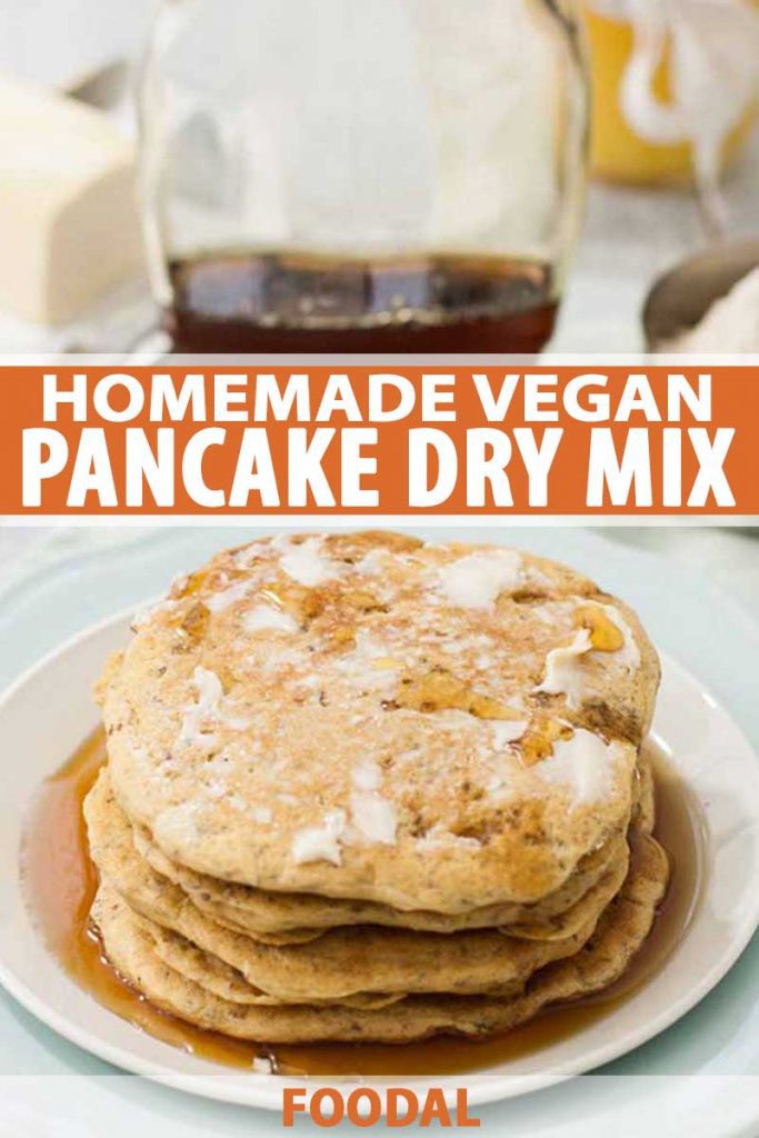 An oblique view of a vegan pancake stack made with a homemade dry mix recipe. A bottle of maple syrup is in the background.