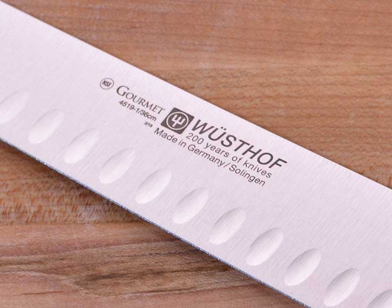 A close up showing the laser etching on the blade of the Wusthof Gourmet 14-Inch Brisket Slicer.