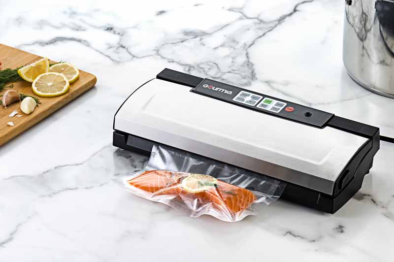 The Gourmia GVS435 Stainless Steel Vacuum Sealer on a marble kitchen counter.