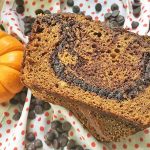 Horizontal image of slices of pumpkin bread with chocolate swirls.
