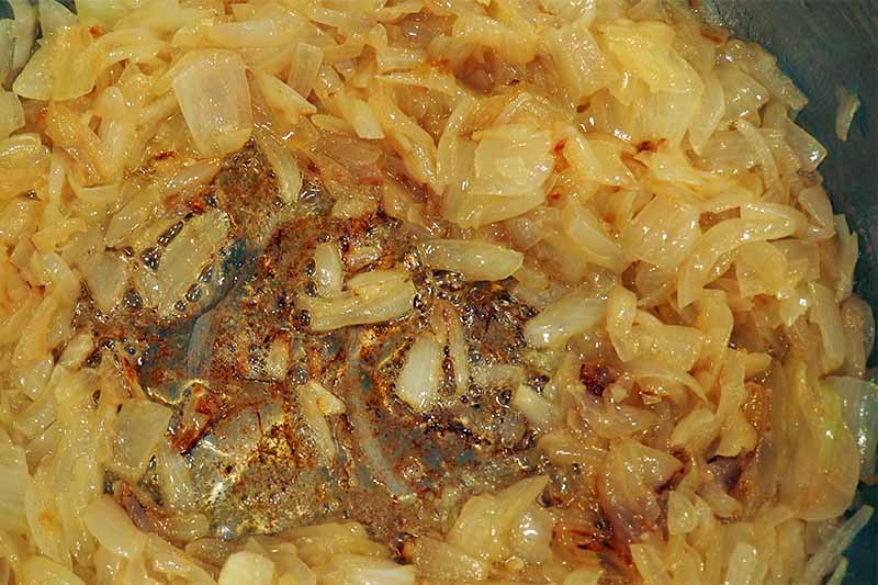 Closeup of chopped caramelized onions cooking.