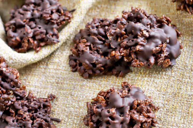 Crisped rice and chocolate cookie treats, on a burlap background.