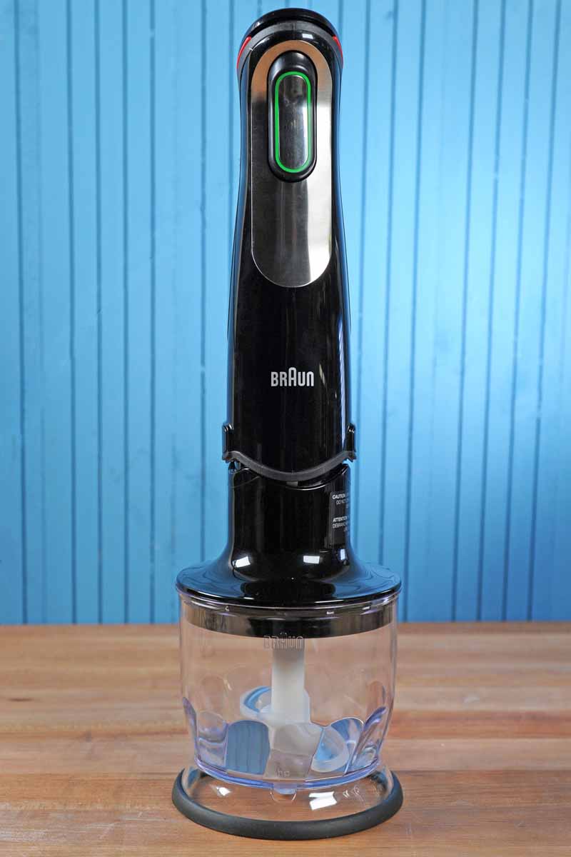 Braun MQ725 Multiquick with 1.5 cup food chopper Attached. On a blue painted wooden background.