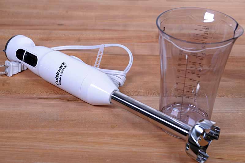 Oblique view of the the Cuisinart CSB-175 Smart Stick Immersion Hand Blender on a maple butcher block countertop.