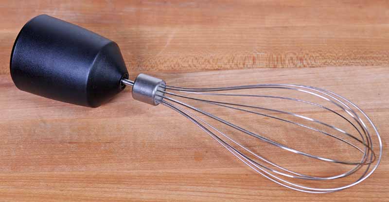 A close up of the Cuisinart CSB-179 Smart Stick Whisk Attachment laying on a maple wooden surface.