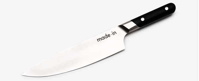 Image of Made In's Chef's Knife with a black handle.