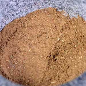 A close up of a poultry seasoning blend in a stone mortar.