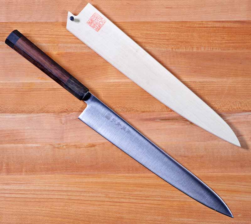 Top-down view of the Yoshihiro Ice Hardened 10.5-Inch Stainless Steel Wa Sujihiki on a maple cutting block.