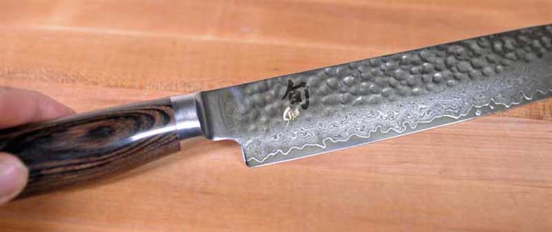 Closeup of the blade of a Shun Premier Sujihiki.