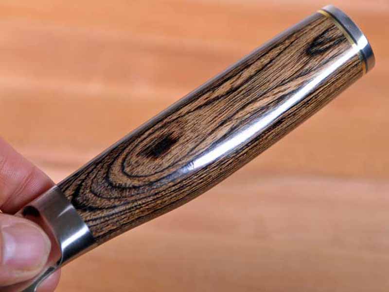 A closeup of the stabilized wooden handle of the Shun Premier Sujihiki.