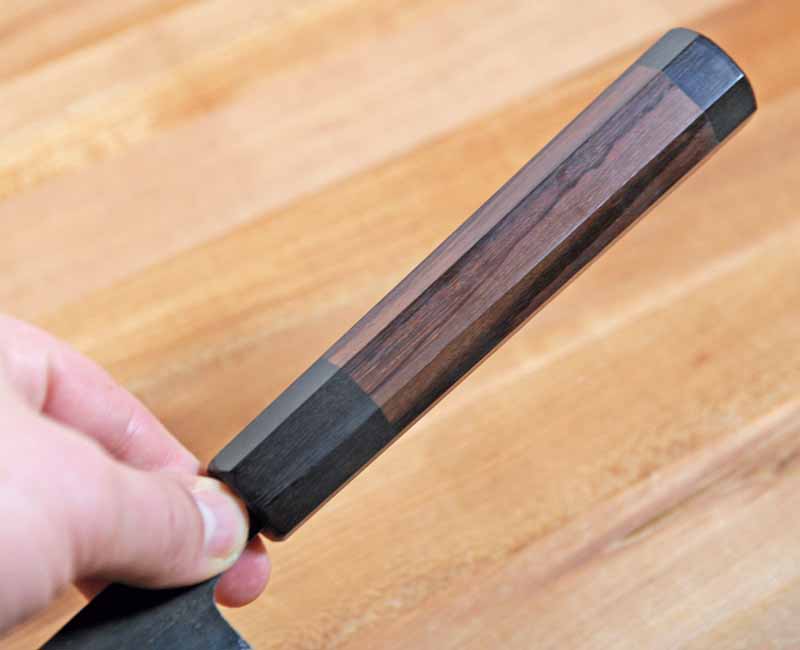 A closeup of the traditional wa rosewood handle found on the Yoshihiro Mizu Aogami.