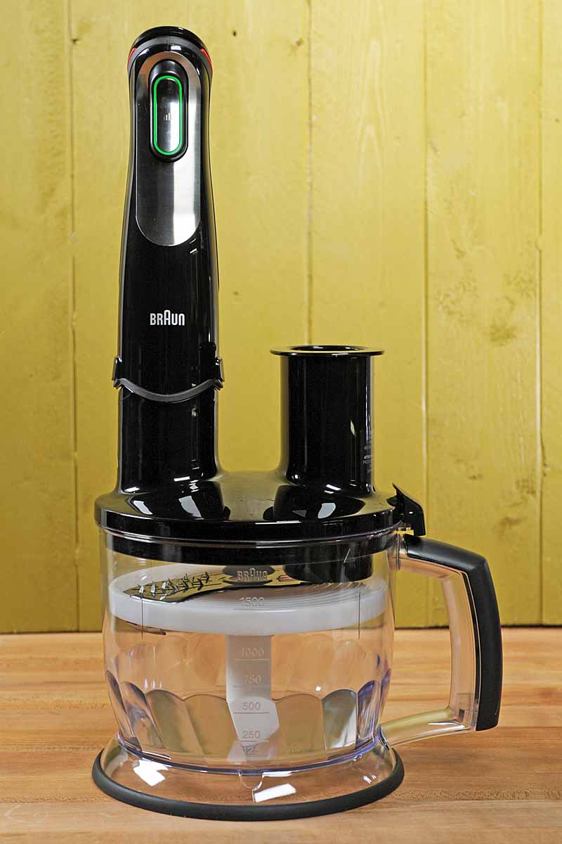 The Braun MQ777 Motor Base Attached to the included 6-cup Food Processor Accessory on a lime green background.